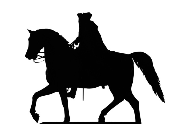 Ein Scherenschnitt eines Reiters auf einem Pferd.