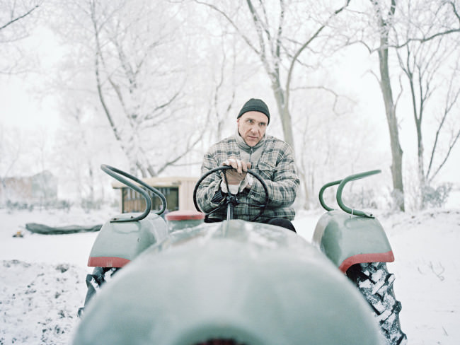 Winter: Ein Mann auf dem Tracktor. 