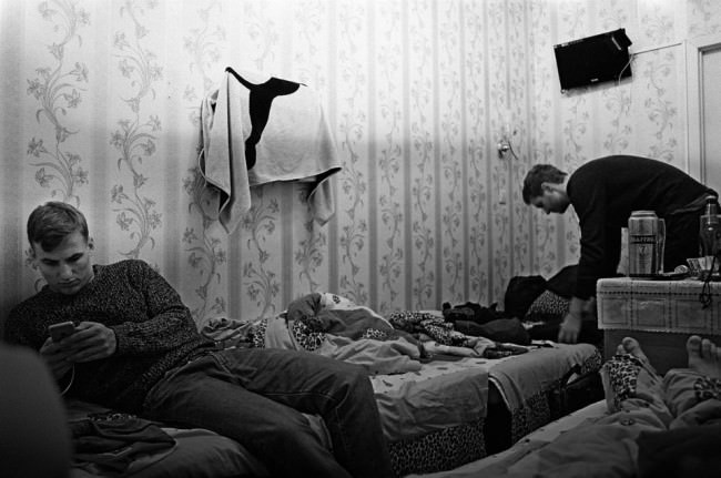 Zwei junge Männer in einem kleinen Schlafzimmer