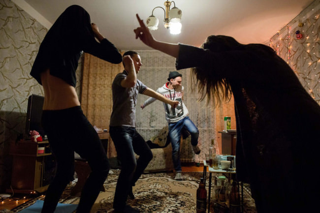 Menschen tanzen in einem Wohnzimmer