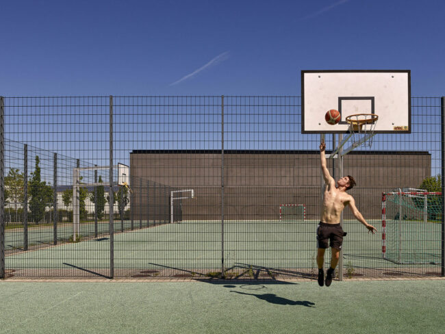 Mann wirft einen Ball in einen Basketballkorb