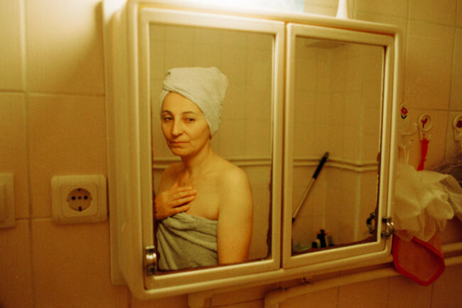 Frau im Badezimmerspiegel
