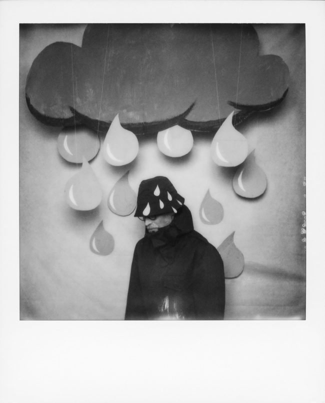 Person mit Pappwolke und Regentropfen