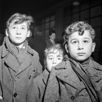 Drei Jungen in Wintermändeln.